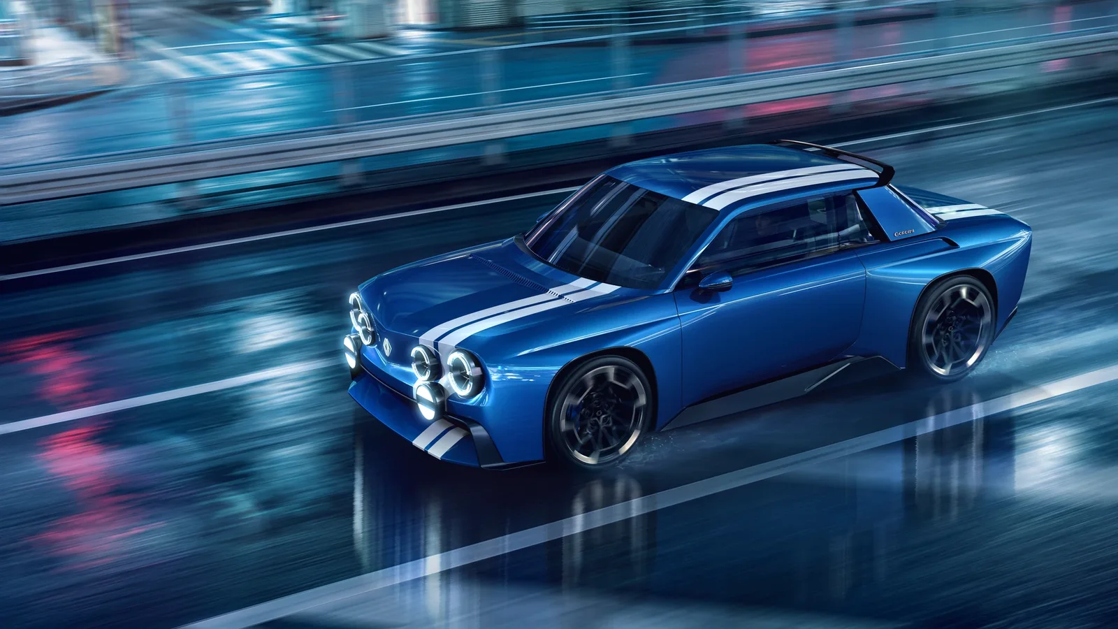 Renault 8 Gordini Concept albastru, fotografiat în mișcare pe un bulevard urban ud, pe timp de noapte.